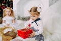 Cute beautiful girl opens Christmas gift Royalty Free Stock Photo