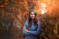 Cute beautiful smile woman walking in red autumn park Royalty Free Stock Photo