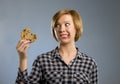 Cute beautiful woman with chocolate stain in mouth eating big delicious cookie Royalty Free Stock Photo