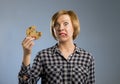 Cute beautiful woman with chocolate stain in mouth eating big delicious cookie Royalty Free Stock Photo