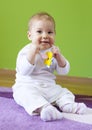 Cute beauty baby child sit and chew toy Royalty Free Stock Photo