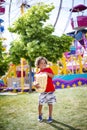 Cute bi-racial little boy eating a big bag of popcorn at an outdoor carnival. Royalty Free Stock Photo