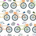 Cute bicycles with wicker baskets. Vector seamless pattern in flat style. background for printing on paper, fabric, clothes. Royalty Free Stock Photo