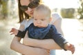 Cute big sister holding her baby brother by city fountain. Adorable teenage girl playing with her baby boy brother. Children Royalty Free Stock Photo