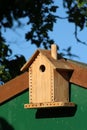 Cute bird box on garden shed in sunlight Royalty Free Stock Photo