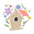 Cute birdhouse on the background of spring flowers. Wooden house for birds. Spring concept. Royalty Free Stock Photo