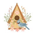 Cute birdhouse with birds, decorated with flowers and leaves. Spring clip art in flat cartoon style.