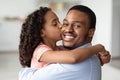 Cute black girl kissing her smiling father, closeup Royalty Free Stock Photo