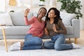 Cute black girlfriends taking selfie together on phone Royalty Free Stock Photo