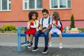 Cute Black schoolboy and girl are eating outdoors next the school. Royalty Free Stock Photo