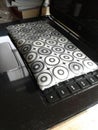 A cute black and white pencilcase on a black modern laptop