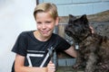 Boy and his friend a brown cairn terrier