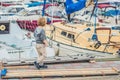 Cute blond boy looking at yachts and sailboats Royalty Free Stock Photo