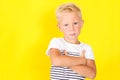 Cute blond boy portrait on yellow background Royalty Free Stock Photo