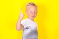 Cute blond boy portrait on yellow background Royalty Free Stock Photo