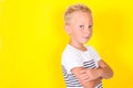 Cute blond boy portrait on yellow background Royalty Free Stock Photo