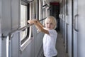 Cute blond boy traveling by train. Children in railroad car Royalty Free Stock Photo