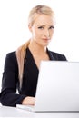 Cute blond business woman working on laptop