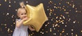 Cute blond caucasian baby with star balloon in hands at black bokeh background, Royalty Free Stock Photo