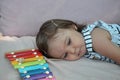 Cute blond child playing with xylophone at home. Creativity and education concept. Royalty Free Stock Photo
