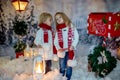 Cute blond children, boy and girl, siblings, posting Christmas letter to Santa Claus, winter day Royalty Free Stock Photo