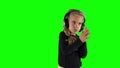 Cute blond girl listening to music and clap hands in tact. Chroma Key