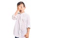 Cute blond kid wearing elegant shirt peeking in shock covering face and eyes with hand, looking through fingers with embarrassed Royalty Free Stock Photo