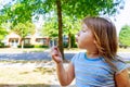 Cute blond little girl blowing a dandelion Royalty Free Stock Photo