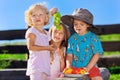 Cute blond little girl and boy playing with fruits Royalty Free Stock Photo