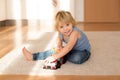 Cute blond toddler child, playing with big toy car Royalty Free Stock Photo