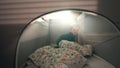 Cute blond toddler hides in play tent installed in bedroom