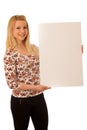Cute blond woman with blank white banner isolated over white background Royalty Free Stock Photo