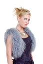 Cute blond woman wearing a purple dress a fur vest Royalty Free Stock Photo