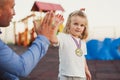 Cute blonde baby child gives high five hands with his father Royalty Free Stock Photo