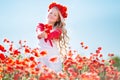 Cute blonde child girl in poppy field Royalty Free Stock Photo