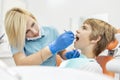 Dentist Examining the Young Patient`s Mouth