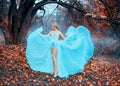 Cute blonde elf waves a seductive watercolor evening dress, shows long legs. Royalty Free Stock Photo