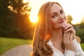 Cute blonde girl on background of sun. Ordinary happy woman enjoying life in summer Royalty Free Stock Photo