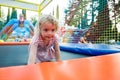 Cute blonde girl having fun at outdoor trampolin. Royalty Free Stock Photo