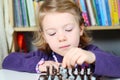 Cute, blonde girl playing chess Royalty Free Stock Photo