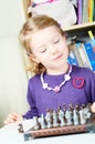 Cute, blonde girl playing chess Royalty Free Stock Photo