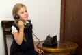 Cute blonde girl talking on vintage telephone Royalty Free Stock Photo