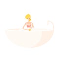 Cute blonde girl washes a bath with a rag in a pink apron.