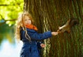 A cute blonde girl 6 years old smiling and feeding a squirrel in Royalty Free Stock Photo