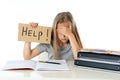 Cute blonde hair school girl holding a help sign in a education concept Royalty Free Stock Photo