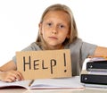 Cute blonde hair school girl holding a help sign in a education Royalty Free Stock Photo