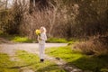 cute blonde happy little girl with yellow daffodils in the spring country Royalty Free Stock Photo