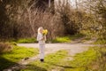 Cute blonde happy little girl with yellow daffodils in the spring country Royalty Free Stock Photo