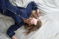 Cute blonde in her bed in blue pajamas and sleep mask. Royalty Free Stock Photo