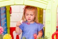 A cute blonde little girl with a funny face, blowing soap bubbles Royalty Free Stock Photo